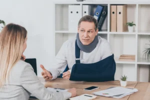 Injured man consulting with a lawyer after a car accident